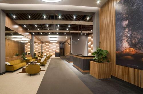 a lobby with a waiting room with yellow chairs at Radisson Blu Hotel, Mount Erciyes in Erciyes