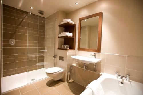 a bathroom with a sink and a toilet and a mirror at Kingsmills Hotel in Inverness