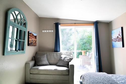 a living room with a couch and a window at Hope Alaska's Bear Creek Lodge in Hope