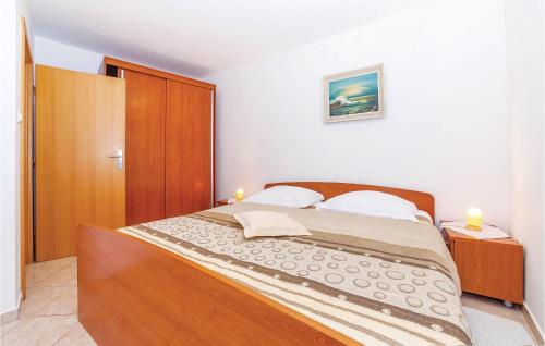 a bedroom with a large bed in a room at Nice Home In Dramalj With Wifi in Dramalj