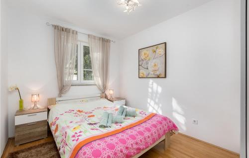 a white bedroom with a bed with a pink blanket at Beautiful Apartment In Cizici With Wifi in Čižići