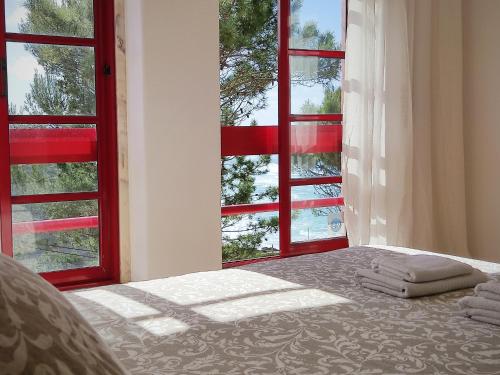a bedroom with a bed and a window with towels on it at Magoito Beach Apartment in Sintra