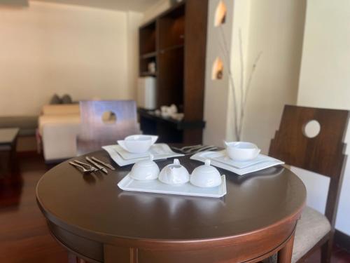 a table with plates and bowls on top of it at Patong Paragon Resort & Spa SHA Extra Plus in Patong Beach