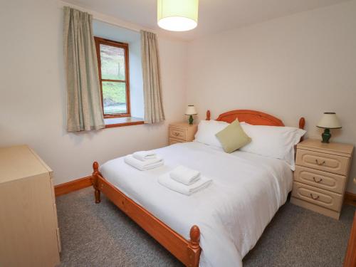 a bedroom with a bed with two towels on it at Campbell in Pitlochry