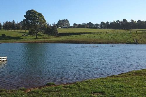 a lake with a boat in the middle of a field at Spiritwood, BnB for 2 in a quiet rural setting in Lower Barrington