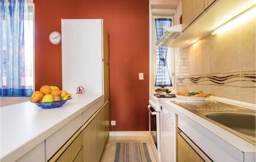 a kitchen with a bowl of fruit on a counter at Gorgeous Apartment In Rijeka With Kitchen in Rijeka