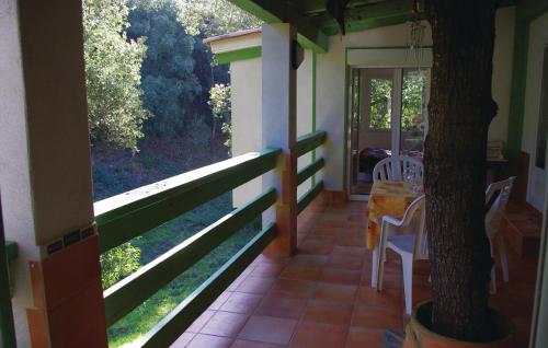 a porch of a house with a table and chairs at Nice Apartment In Sagone With Kitchen in Sagone