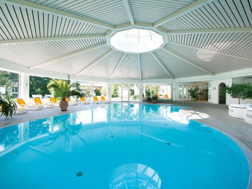 a large swimming pool with a ceiling at Hotel Traube Revital in Wurmlingen