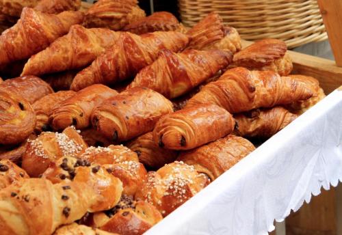 a bunch of pastries and croissants in a box at The Railroad Inn in Cooperstown