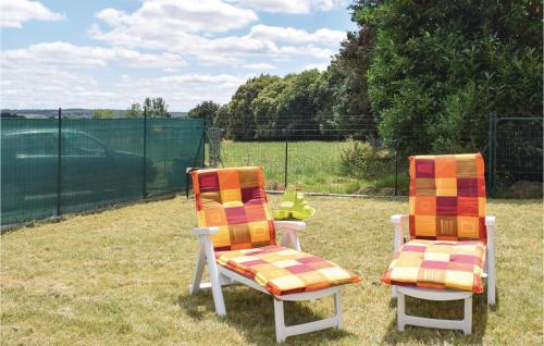 two chairs sitting next to each other in a yard at Awesome Home In Le Cambout With Wifi in Le Cambout
