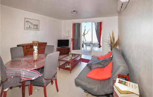 a living room with a couch and a table at 1 Bedroom Lovely Apartment In Propriano in Propriano