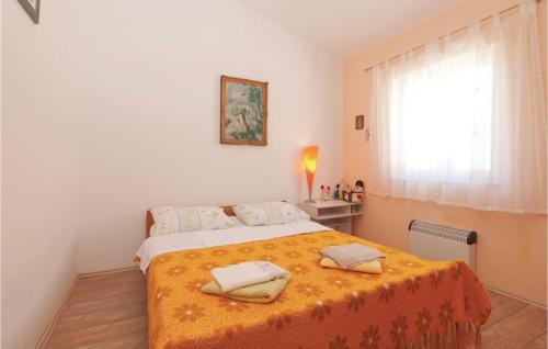 a bedroom with a bed with two towels on it at 1 Bedroom Amazing Apartment In Pag in Pag
