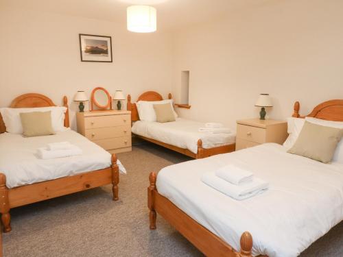 a bedroom with two twin beds and two mirrors at Bruce in Pitlochry