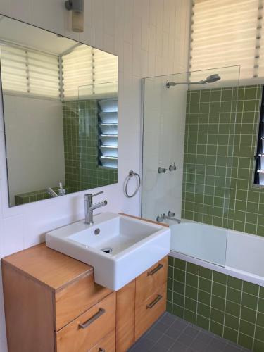 a bathroom with a sink and a mirror at STANLEY COTTAGE in Maclean
