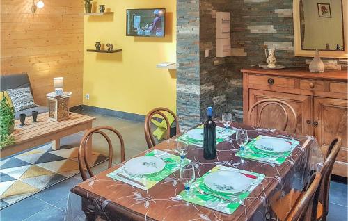 a dining room table with a bottle of wine on it at Gorgeous Home In Mont-Dol With Wifi in Mont-Dol