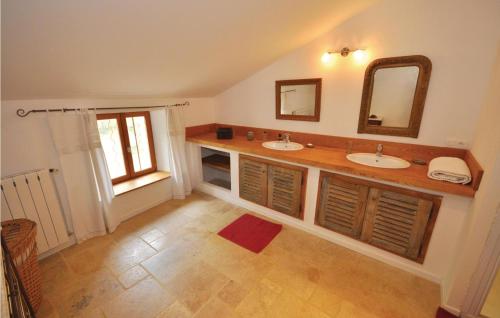 a bathroom with two sinks and a mirror at Stunning Home In Murviel-ls-bziers With 5 Bedrooms, Wifi And Outdoor Swimming Pool in Murviel