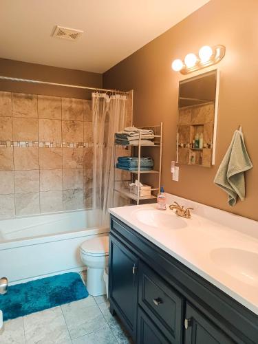 a bathroom with a sink and a shower and a toilet at Huge 2 Bedroom House in the Heart of Northside! in Cincinnati
