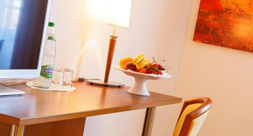 a table with a bowl of fruit on it at Hotel Landgasthof Schönbühl in Schönbühl