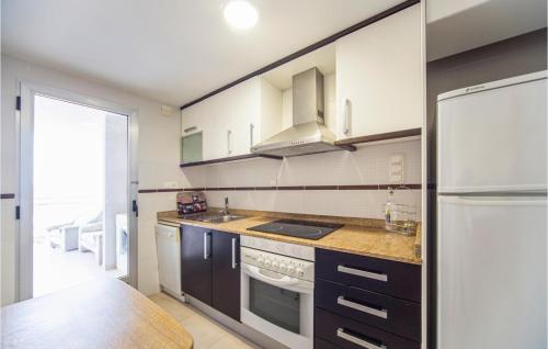 a kitchen with a refrigerator and a stove top oven at Gorgeous Apartment In Oropesa Del Mar in Oropesa del Mar