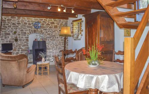 a room with a table and chairs and a fireplace at Lovely Home In Pléhédel With Wifi in Pléhédel