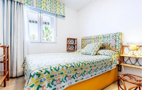 a bedroom with a bed and a window at Amazing Apartment In La Herradura-almuecar With 3 Bedrooms And Wifi in La Herradura