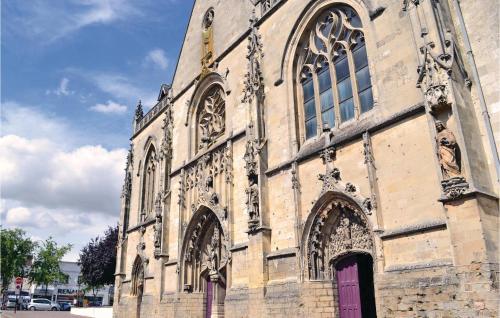 a large stone church with a purple door at Lovely Home In Frise With Wifi in Frise