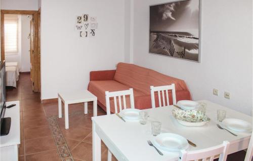 a living room with a table and a couch at 2 Bedroom Cozy Apartment In Lo Pagán in Lo Pagán