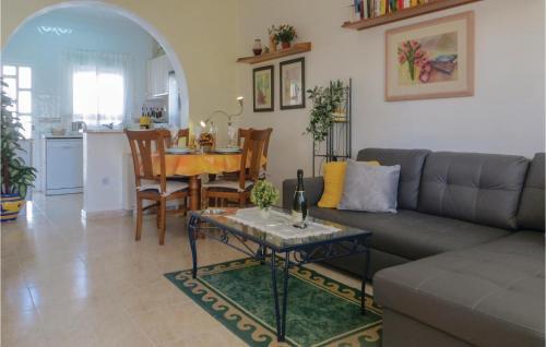 a living room with a couch and a table at Stunning Home In Quesada-Rojales in Rojales