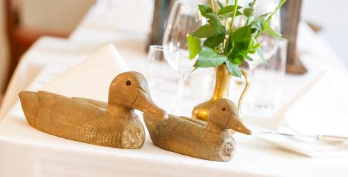 two rubber ducks sitting on a table with a vase at Hotel Landgasthof Schönbühl in Schönbühl