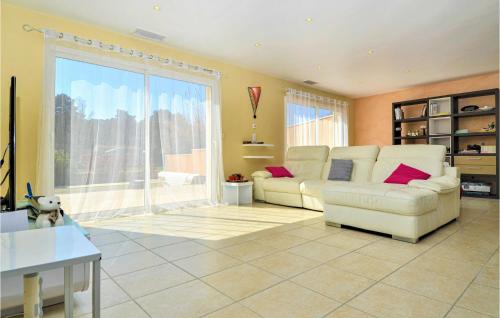 a living room with two white couches and a large window at Gorgeous Home In Mornas in Mornas
