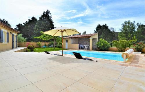 a patio with an umbrella and a swimming pool at Gorgeous Home In Mornas in Mornas