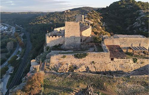 an old castle on top of a mountain with a road at Gorgeous Home In Mornas in Mornas