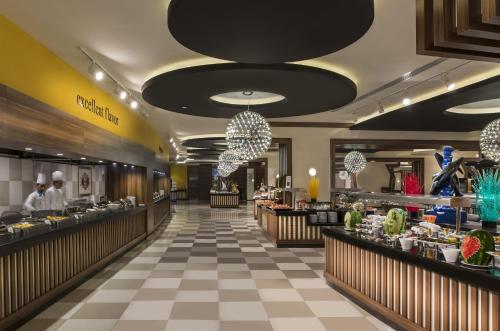 a restaurant with a buffet line with people in the middle at Botanik Platinum Hotel in Okurcalar