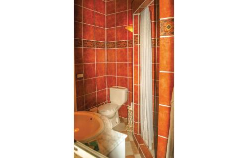 a bathroom with a toilet and a sink at Beautiful Home In Algarrobo With Wifi in Algarrobo