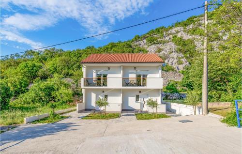 a white house in front of a mountain at 6 Bedroom Stunning Home In Lukovo in Lukovo