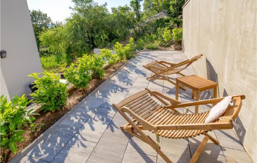 two chairs and a table on a patio at 6 Bedroom Stunning Home In Lukovo in Lukovo