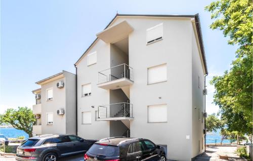 two cars parked in front of a building at Gorgeous Apartment In Povile With Wifi in Povile