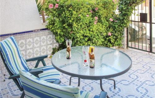 a glass table and chairs on a patio at Two-Bedroom Holiday Home In Los Alcazares in Los Alcázares