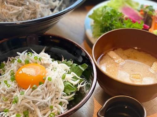 a table with a bowl of food and a bowl of soup at Hiyori Hotel Osaka Namba Station in Osaka