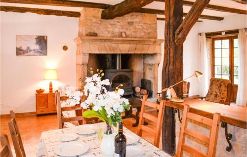 un salon avec une table et une cheminée dans l'établissement 4 Bedroom Cozy Home In Saint Rabier, à Saint-Rabier