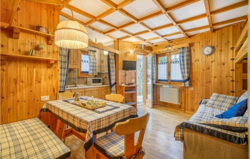 a kitchen and living room with a table and a couch at Cozy Apartment In Ayas With Kitchenette in Champoluc