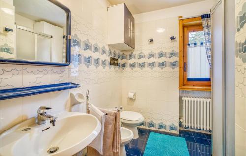 a bathroom with a sink and a toilet at Cozy Apartment In Ayas With Kitchenette in Champoluc