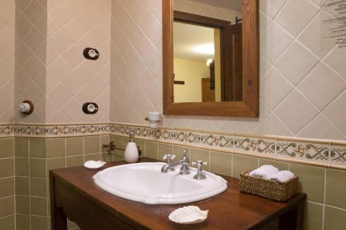 a bathroom with a sink and a mirror at Hotel Triskel in Jávea