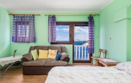 a living room with a couch and a window at Cozy Apartment In Starigrad With House Sea View in Starigrad