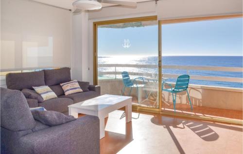 a living room with a couch and a table with chairs at Stunning Apartment In Lloret De Mar in Lloret de Mar