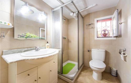 a bathroom with a toilet and a sink and a shower at Villa Carolina Pescola in Peniscola