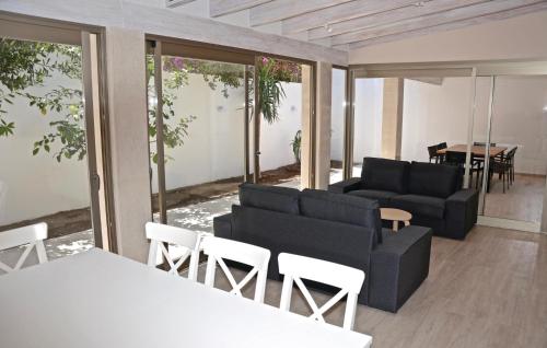 a living room with couches and a table and chairs at Es Molinar in Palma de Mallorca
