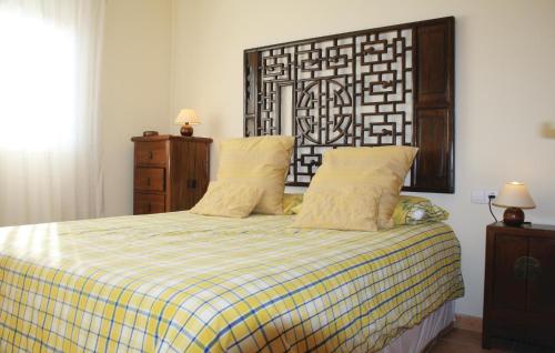a bedroom with a bed with a checkered blanket at Beautiful Home In Altafulla With 3 Bedrooms, Wifi And Outdoor Swimming Pool in Altafulla