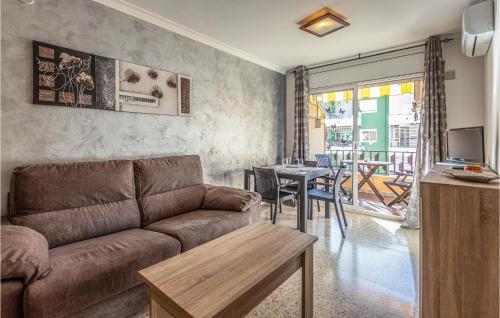 a living room with a couch and a table at Gorgeous Apartment In Pineda De Mar in Pineda de Mar