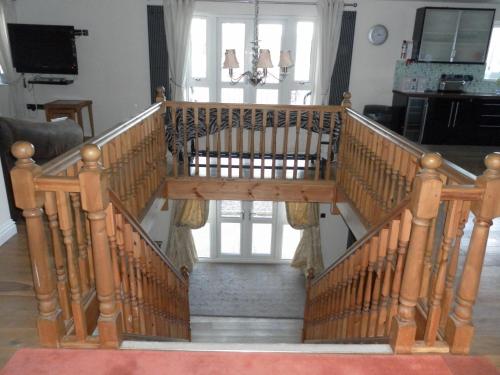 a wooden spiral staircase in a living room at Country House Ashdene in Highworth